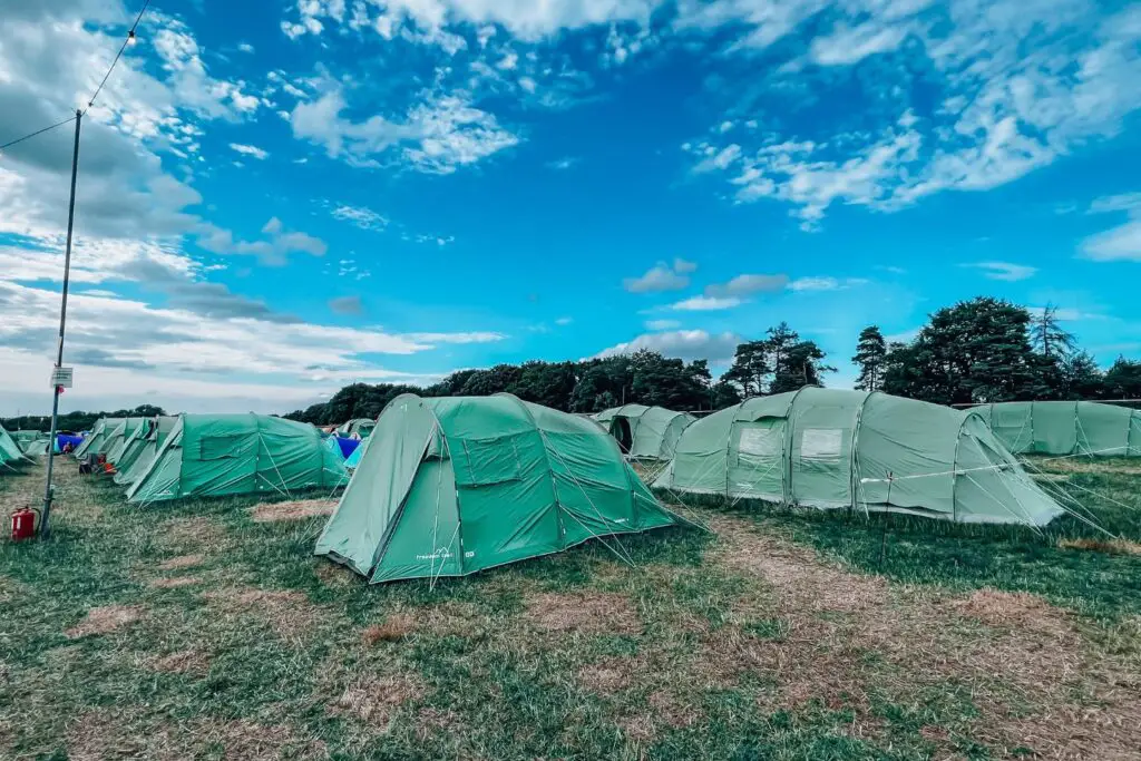 pre-pitched green tents at Camp Wildfire the ones on the right are slightly larger than the left.