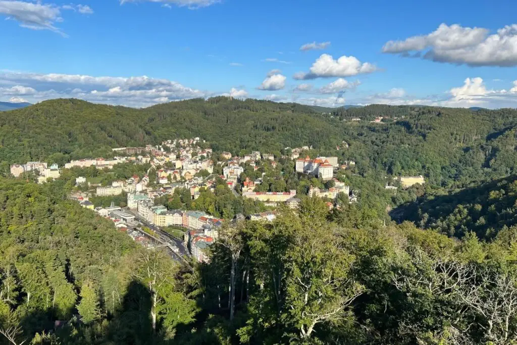 Is Karlovy Vary Worth Visiting? The Diana observation tower view of karlvoy vary with a lot of greenery and terracota houses
